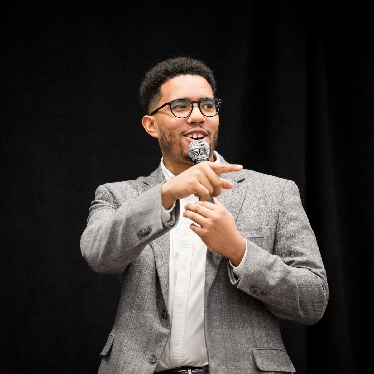 Isaac Etter speaking on stage